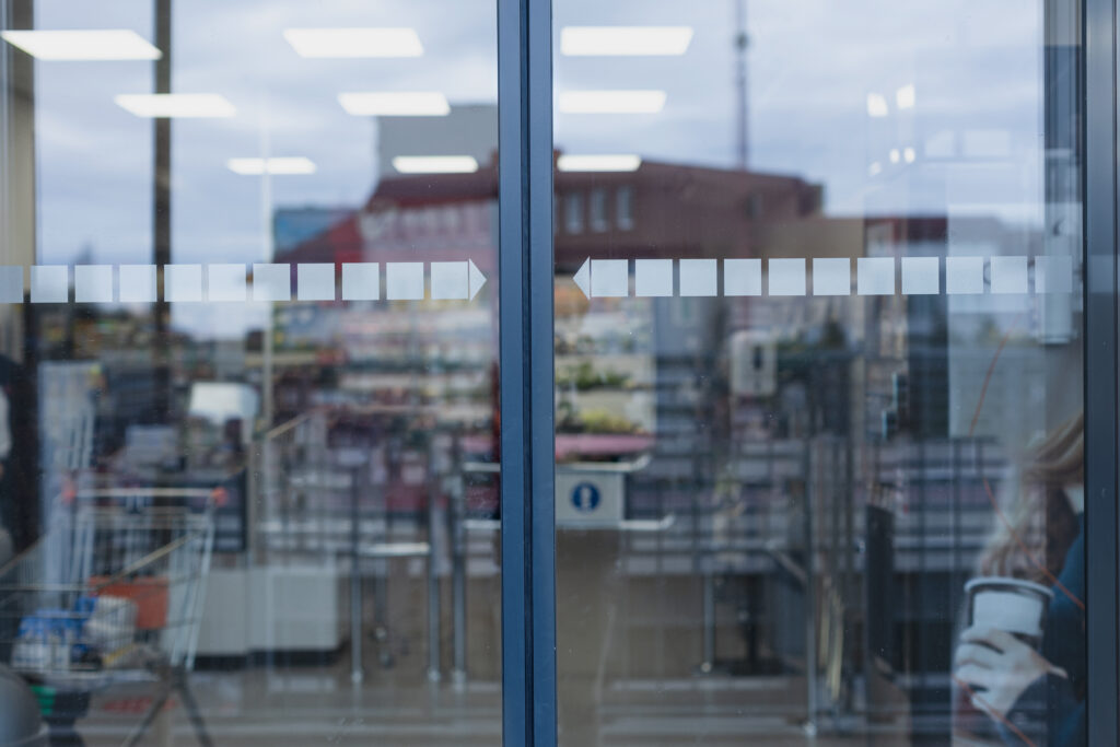 Front view of automatic door representing architectural glass doors in modern retail entrance.